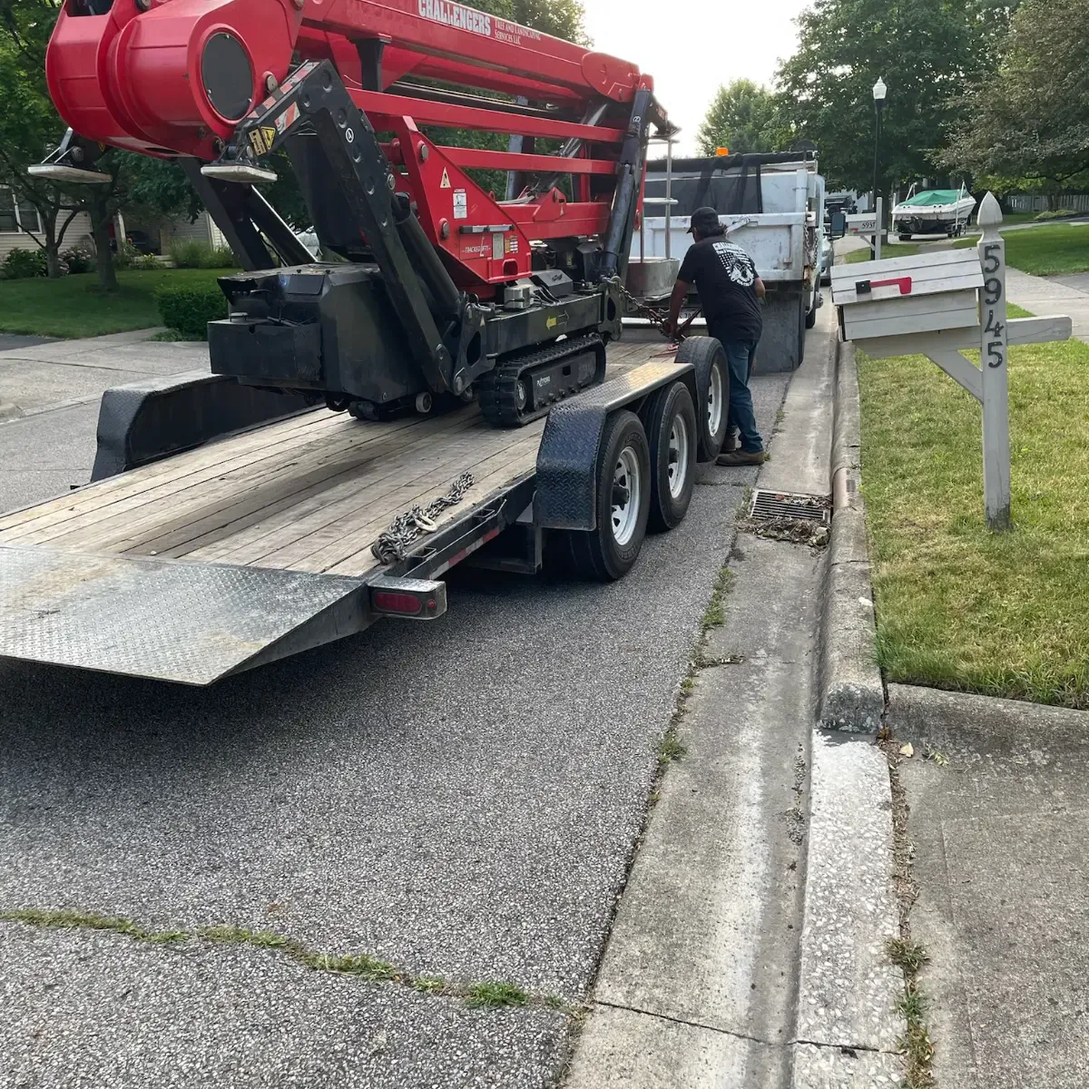 Challengers Tree Service grapple truck and crane on-site during a commercial tree removal in Central Ohio.